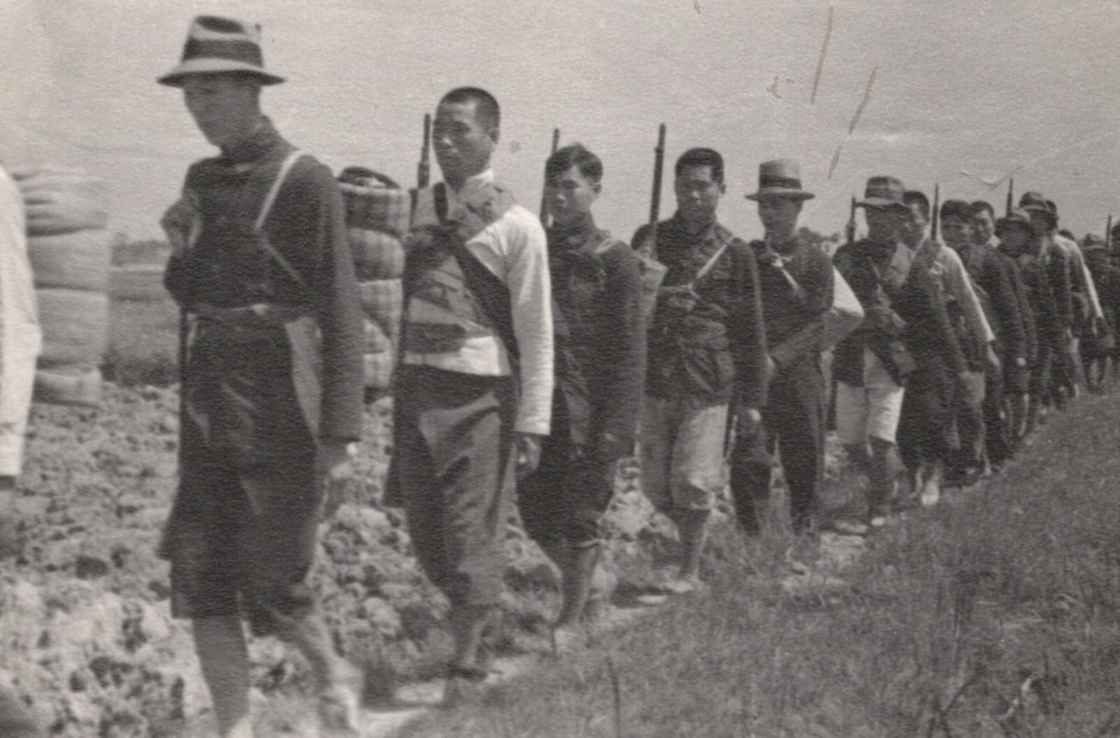 Chinese guerrillas (farmers) who have arisen in the tracks of the Japanese, along the lower Yangtze (Yangzi) River Valley, to fight the invader. They were on their way to join the Communist guerrillas.