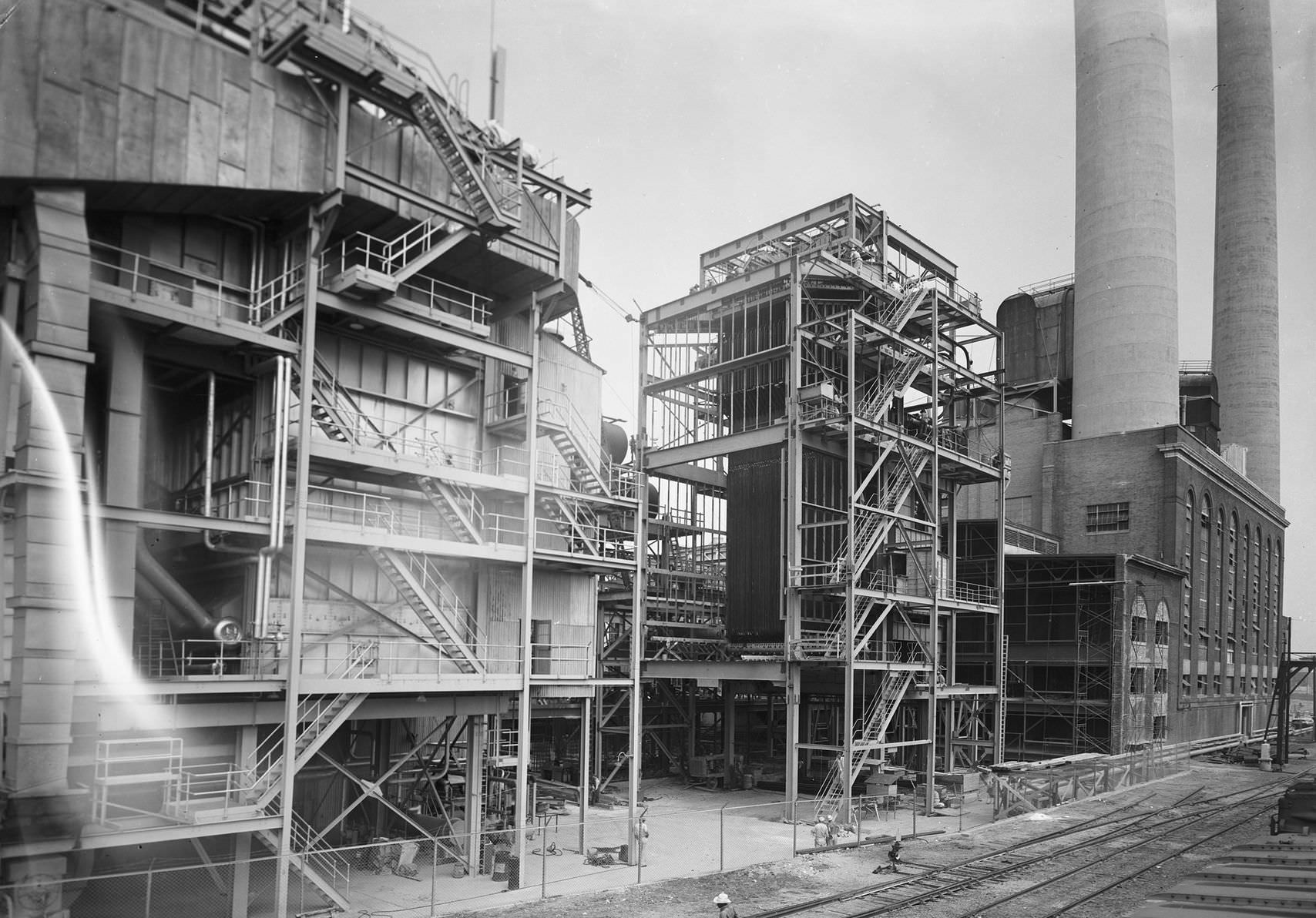 Power plant, downtown Dallas, Texas, 1953. The picture shows a view from outside the power plant in downtown Dallas. There is a railroad next to the plant.