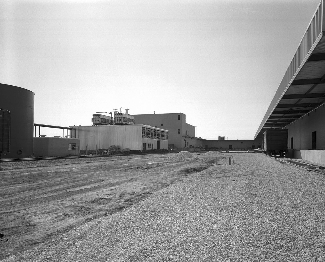 Carling Brewery, Fort Worth, warehouse rail dock and railcar on truck, 1963