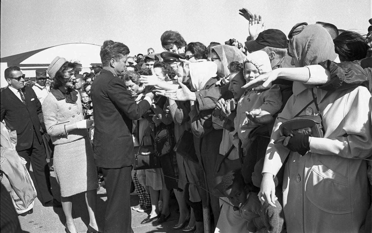 President John F. Kennedy and Jackie shaking hands in crowd just before leaving Carswell Air Force Bas , Fort Worth, 1963