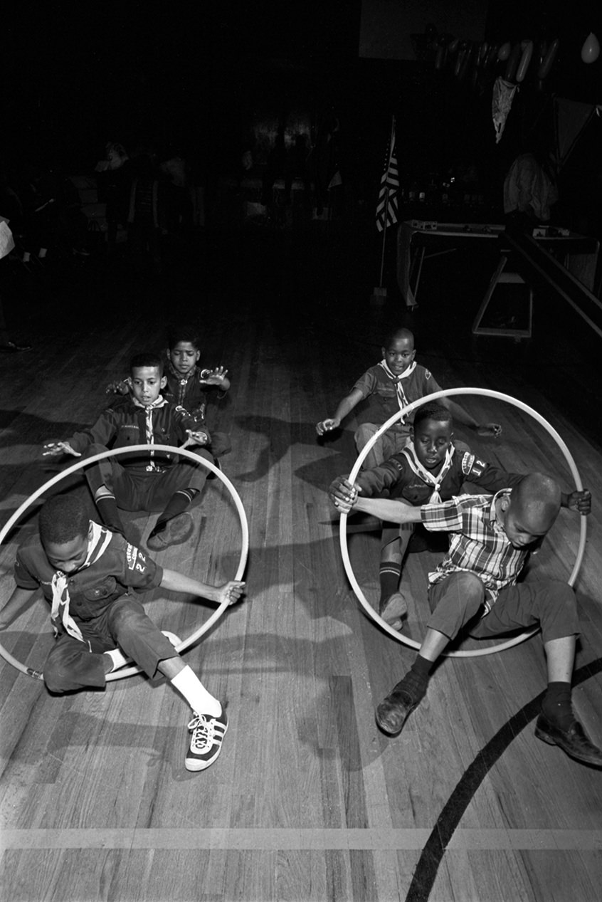 A group of Cub and Boy Scouts at 1968 Cub Scout Olympics competing in a hula hoop race.