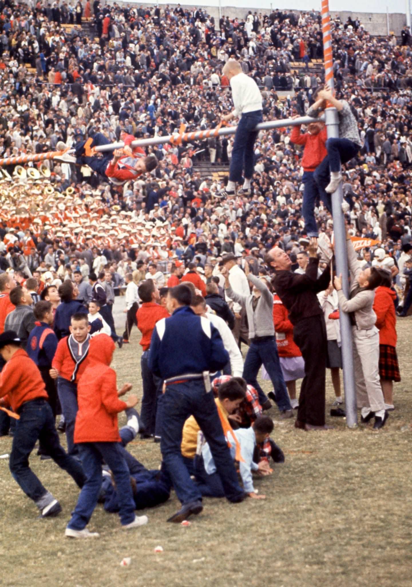 Fans of the Texas Longhorns celebrate and climb on the goal posts after the win against the Texas Christian University Horned Frogs after the rivalry game on November 12, 1960 at Amon G. Carter Stadium in Fort Worth, Texas.