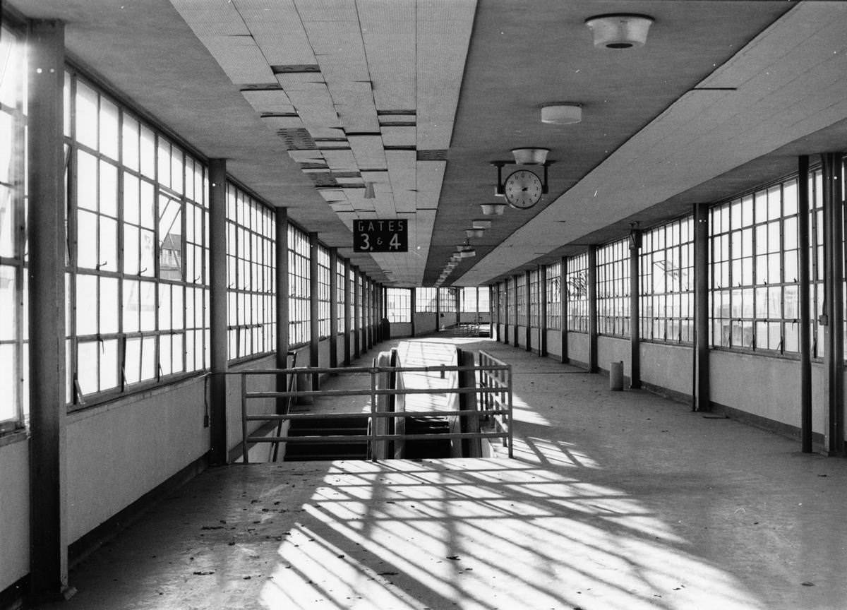 Empty concourse, Gates 3 and 4, clock hanging from ceiling, Greater Southwest International Airport, 1968