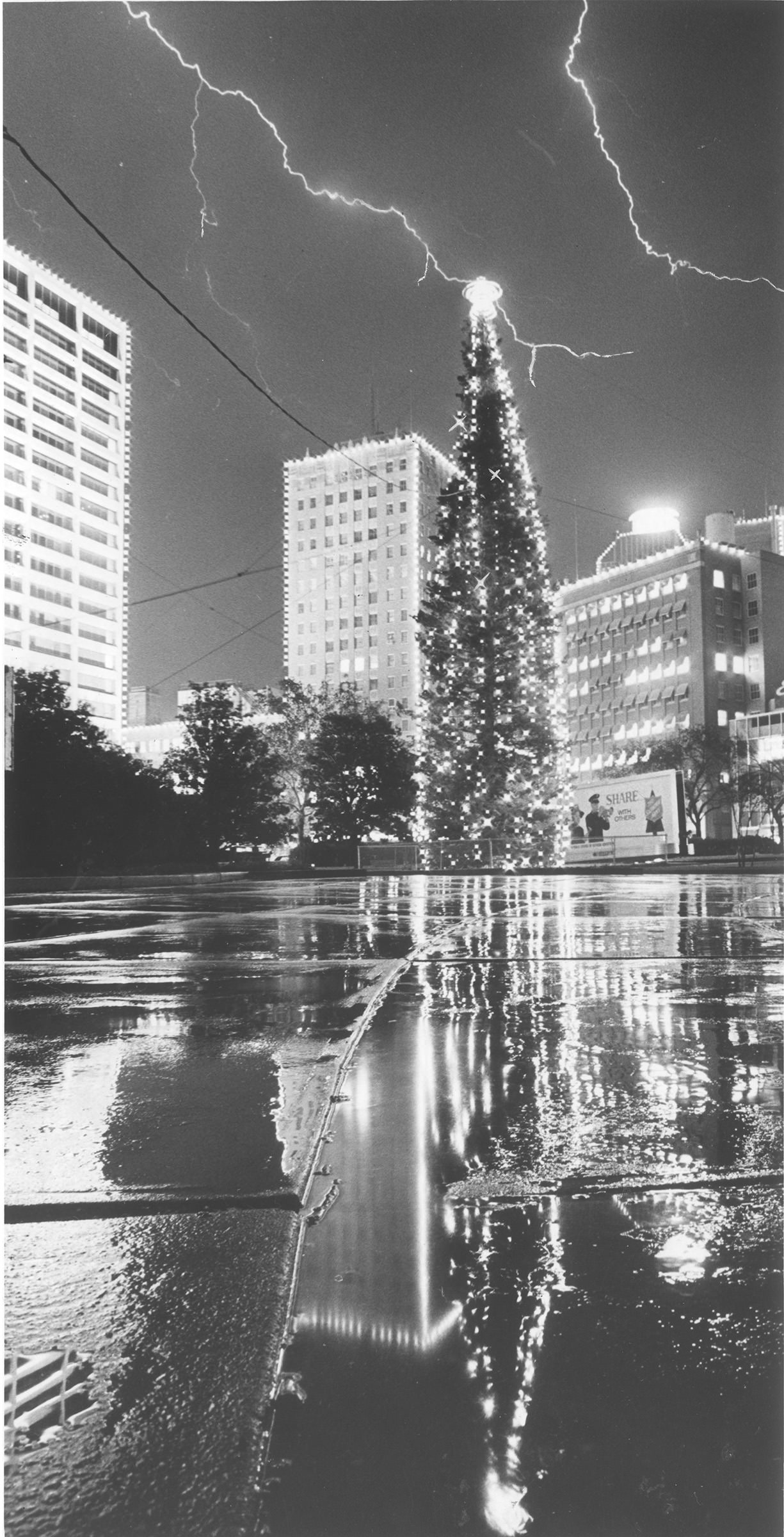 Burnett Park in Fort Worth with lightning flashes over the Christmas Tree, 1966