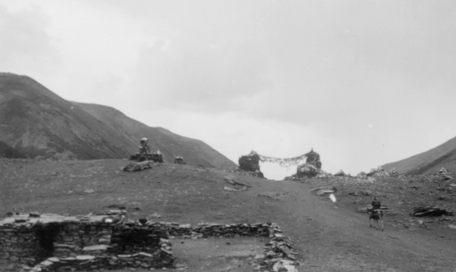 Archway of Stones and Prayer Flags Over the Pass of Kharo-la, 1944. Archway of stones and prayer flags over the 16,400 foot pass of Kharo-la, on road to Lhasa.