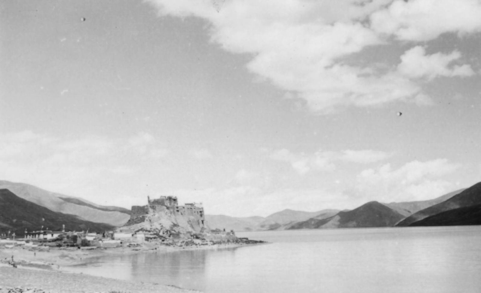 The Yamdrok Lake, 1944. The Yamdrok Lake (more than 14,000 feet above sea level), with the castled town of Pedi on its shore.