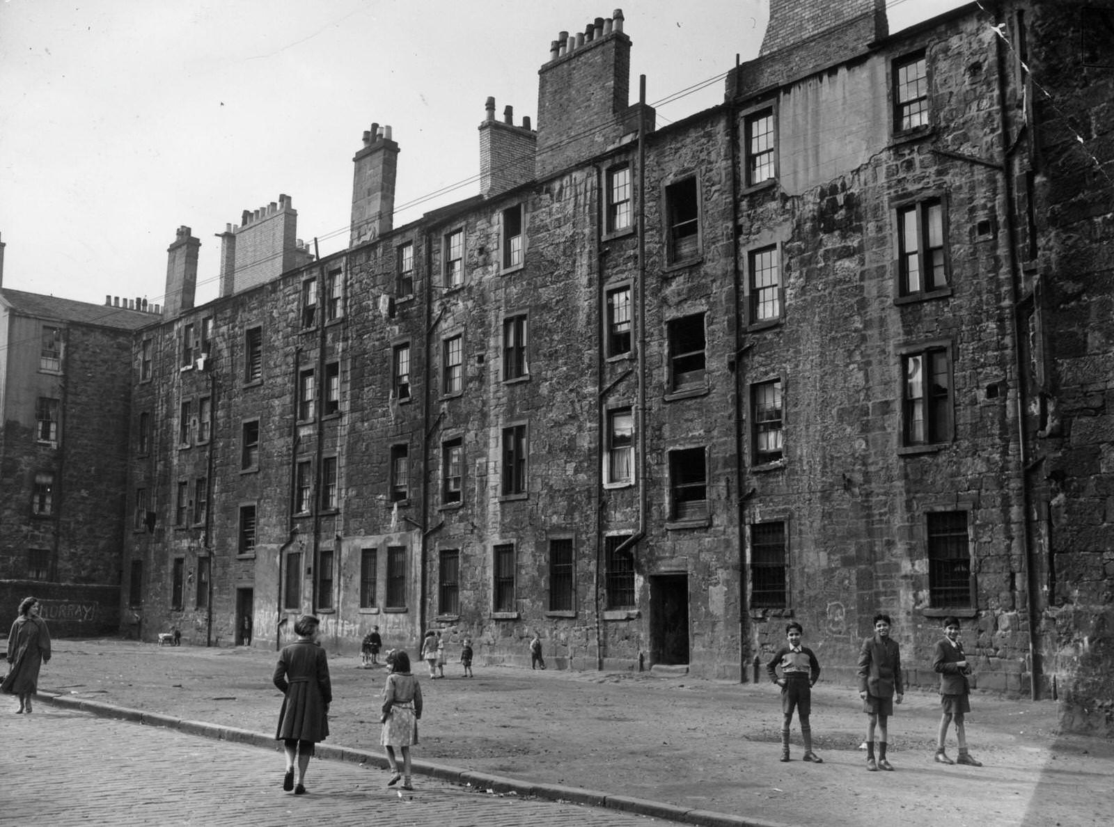 Children play in a yard in Coburg Street, in the Gorbals area of Glasgow, 1956