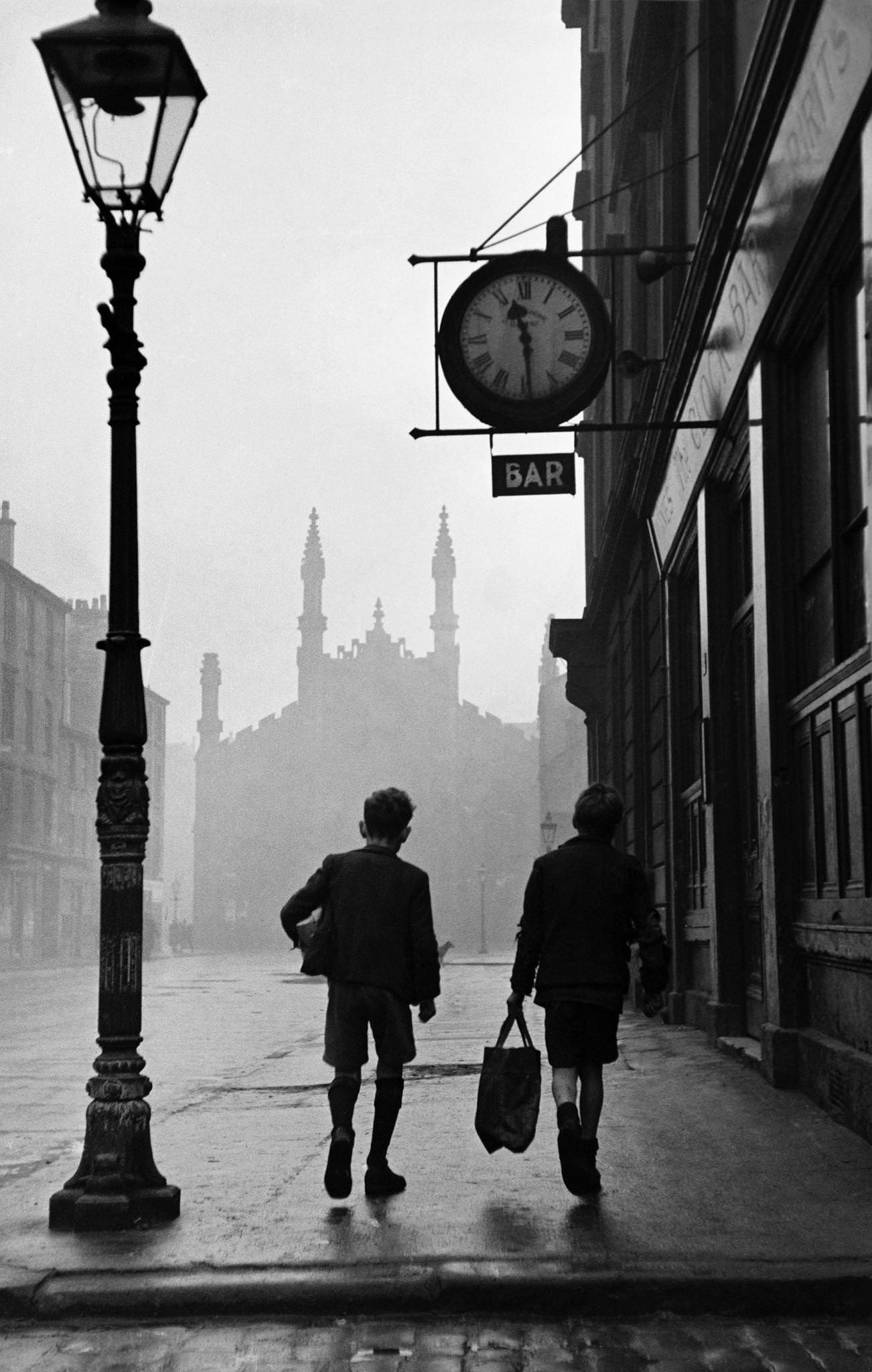 Two boys walk down a street in the Gorbals, a slum area of Glasgow, 1948