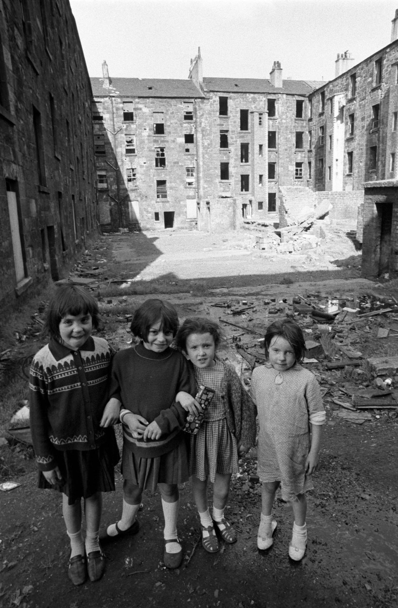 Four little girls posing in front of slum housing in the notorious Gorbals district of Glasgow in 1969.
