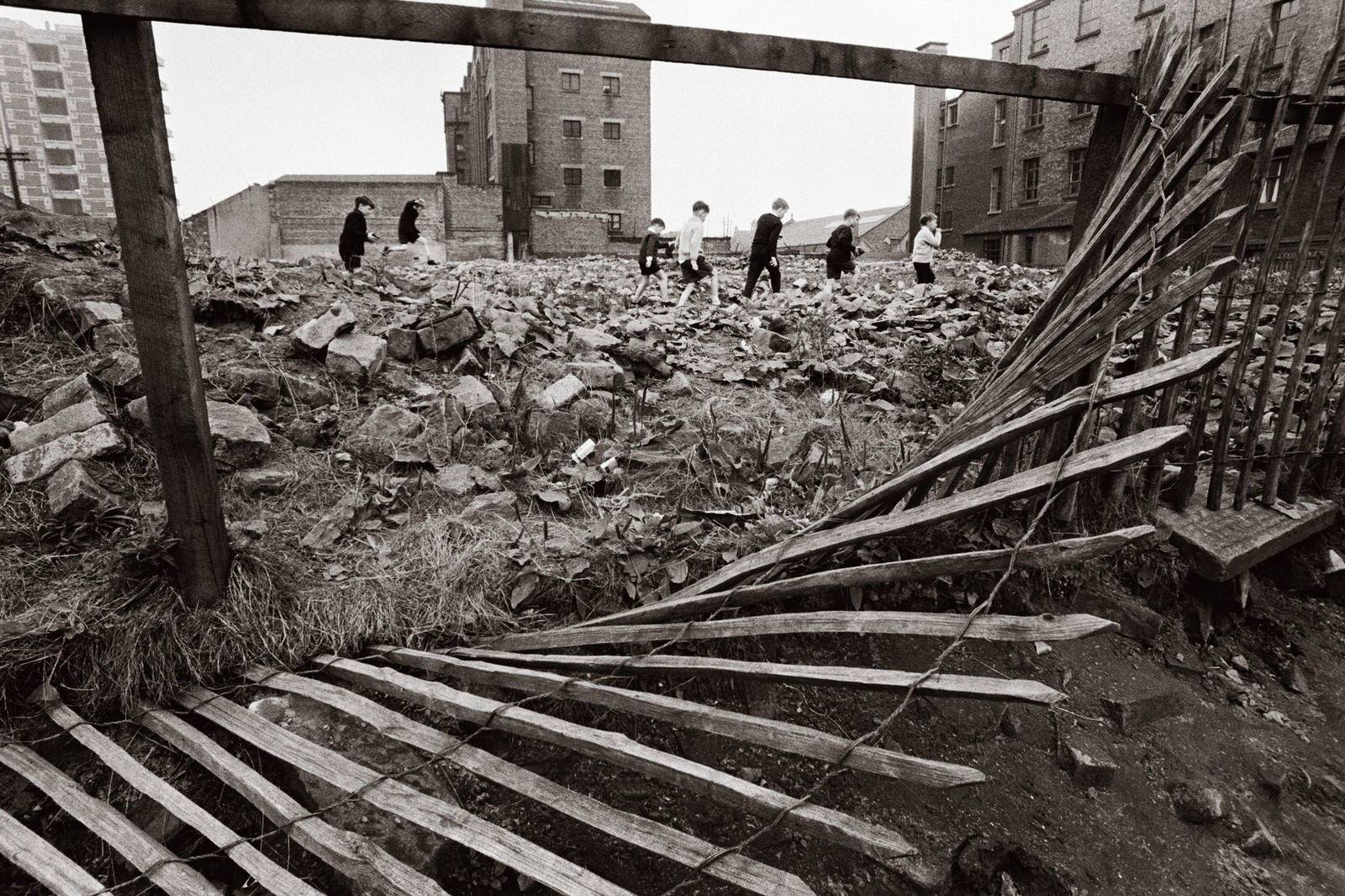 A group of boys pick their way through a wasteland in the Gorbals area of Glasgow, 1968.