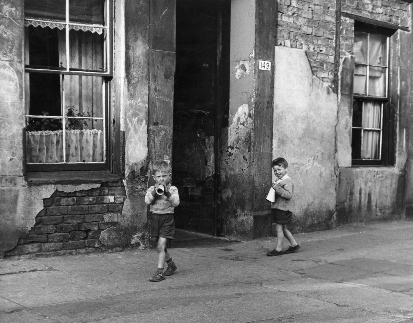 Two young boys playing outside in the Gorbals district of Glasgow, which was described as having the worst slums in Europe, 1960
