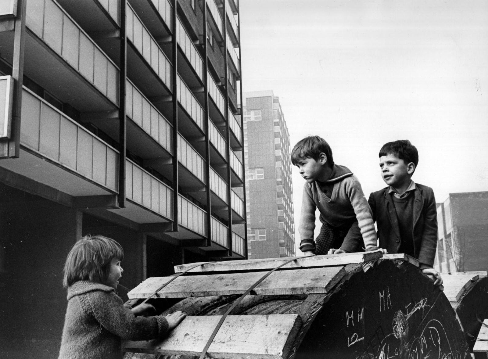 Children playing beside modern tower blocks in the Gorbals area of Glasgow, 1960