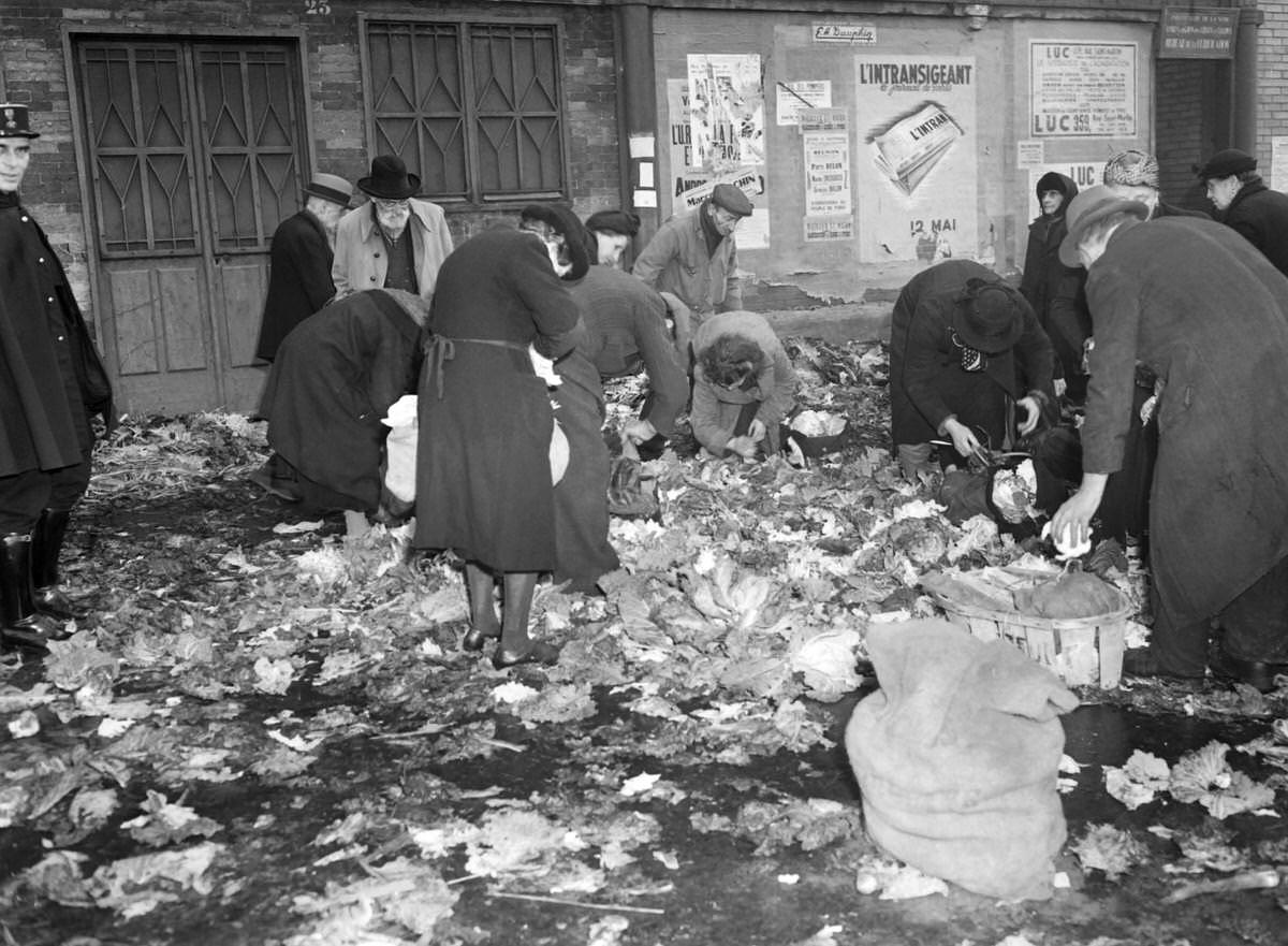 People search for food in the garbage after closing time of the market of Paris Les Halles district on December 28, 1947.