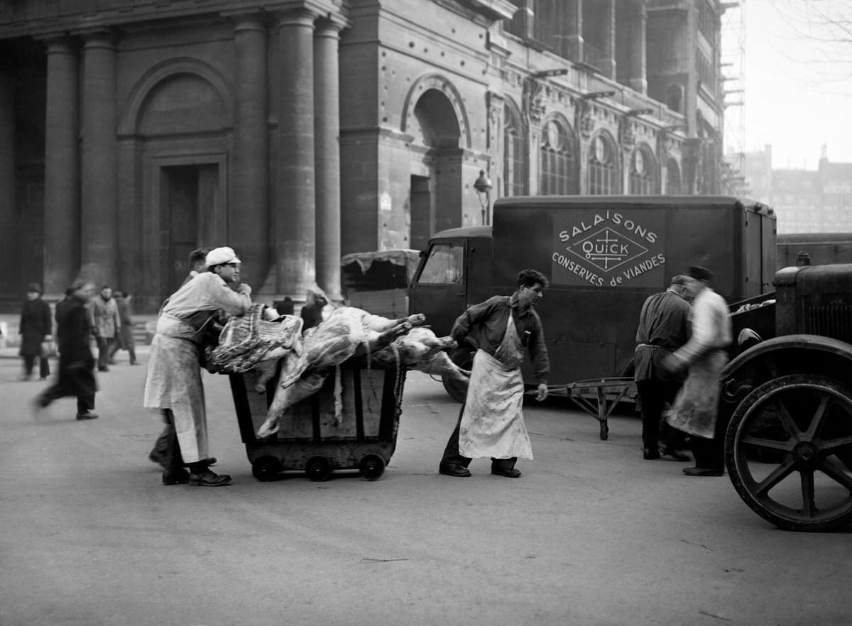 Workers of a butcher's shop carry meat in Les Halles district (central food market) in January 1946 in Paris during the meat strike.