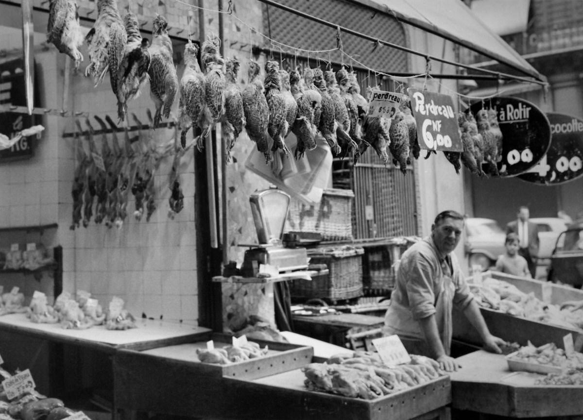 After the opening of the hunt, game is sold by a butcher in a stall in Les Halles on September 6, 1960