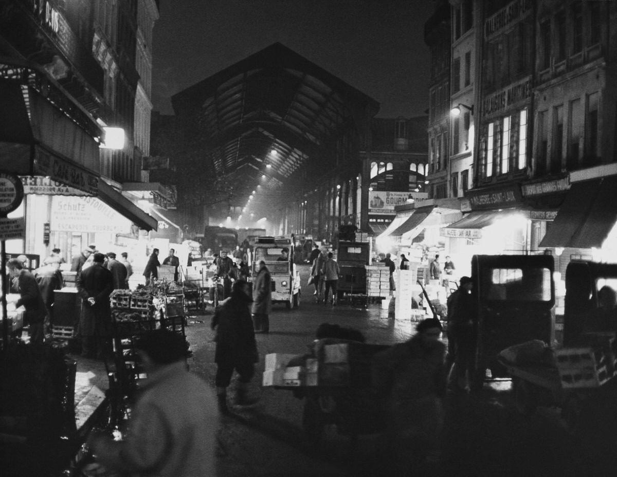 The First stalls lighting up, Les Halles, 1960s