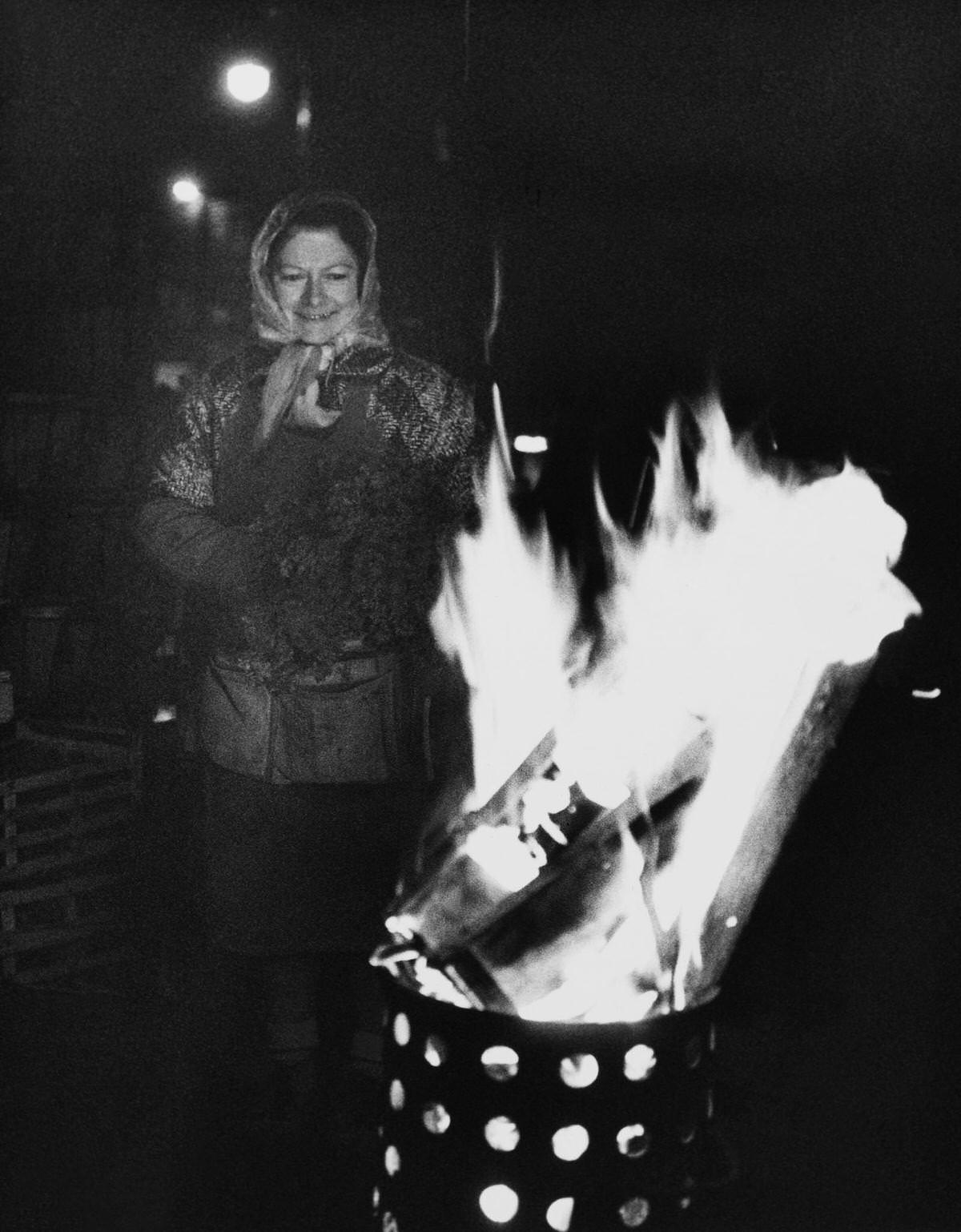 A Woman Warming up in front of a fire, Les Halles, 1960s