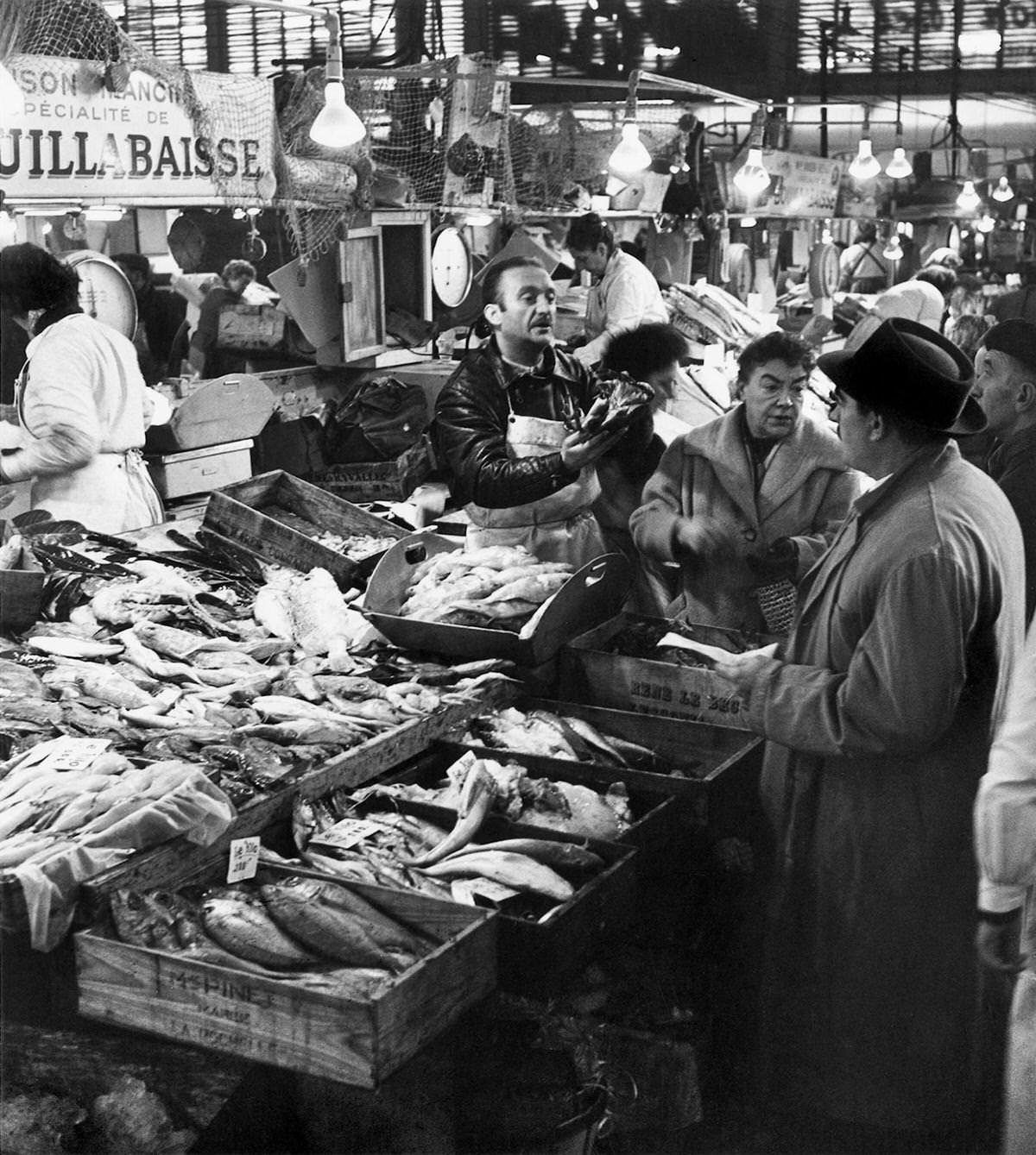 A restaurant owner choosing his products in Les Halles, which was historically the traditional central market of Paris, 1959