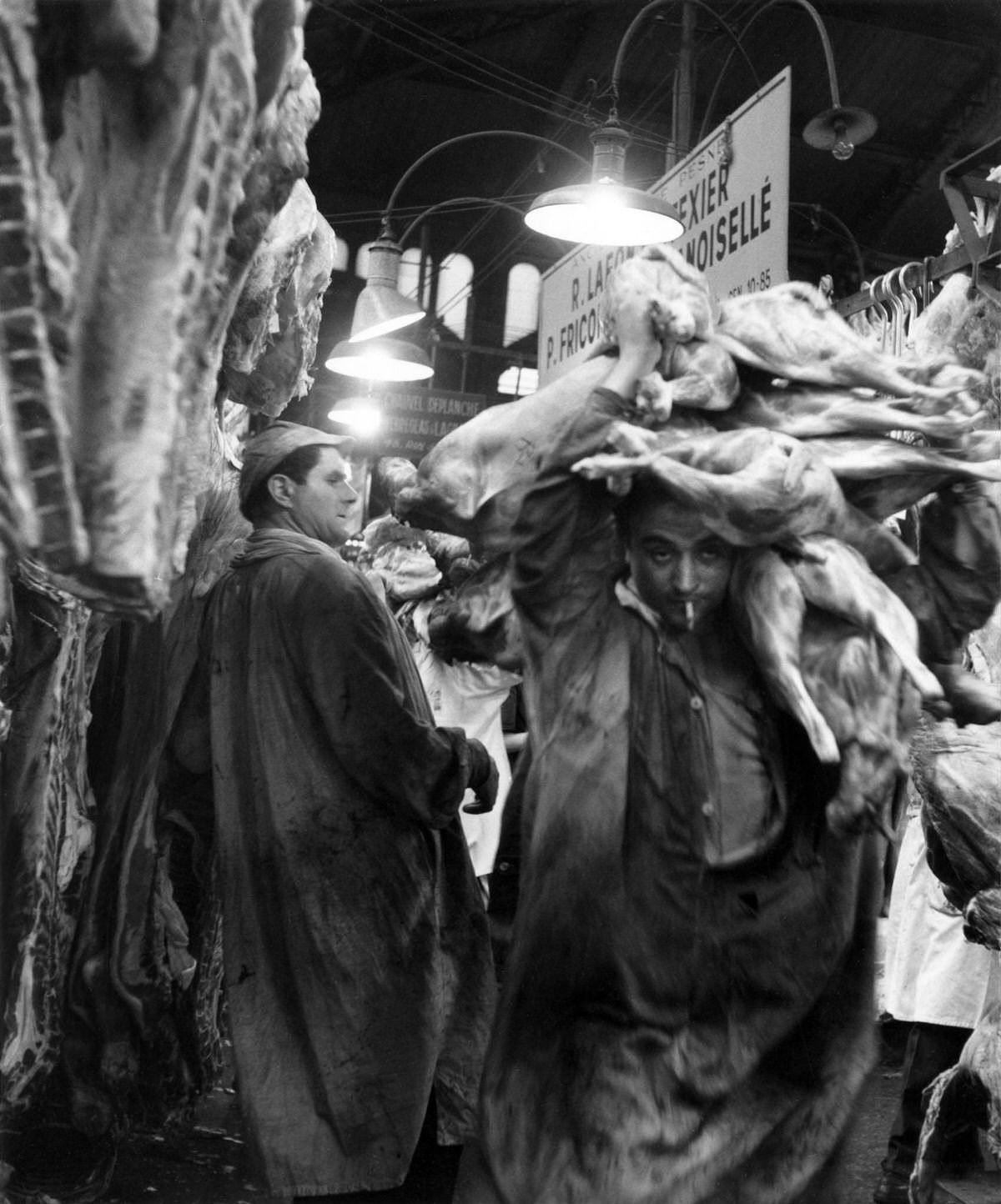 Market porter in the meat hall of Les Halles, which was historically the traditional central market of Paris, those men were called "Forts des Halles", 1955