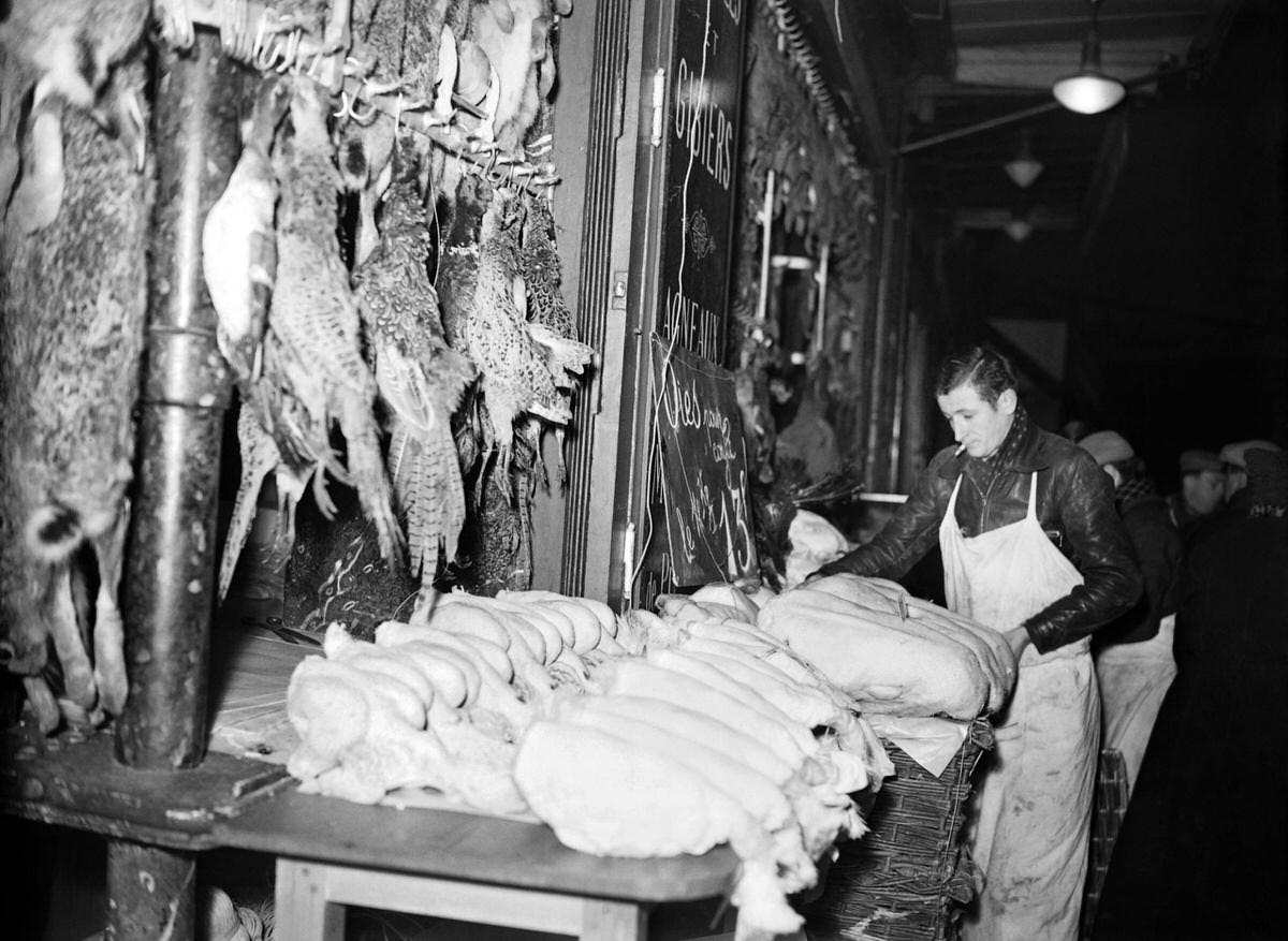 A butcher sets up his poultries at Les Halles district (central food market) in Paris on December 1938.