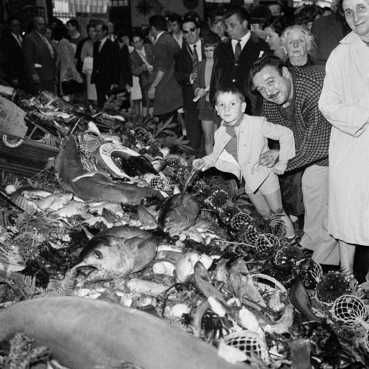 The crowd admires the largest buffet in the world where fish of all kinds are artistically presented for the great fish fair, in Paris, 1967