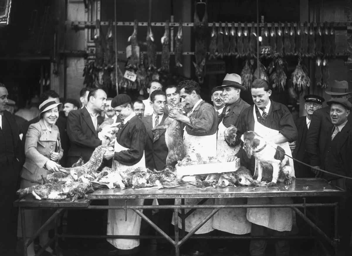 Customers buying game in a store in Les Halles, Paris, 1936