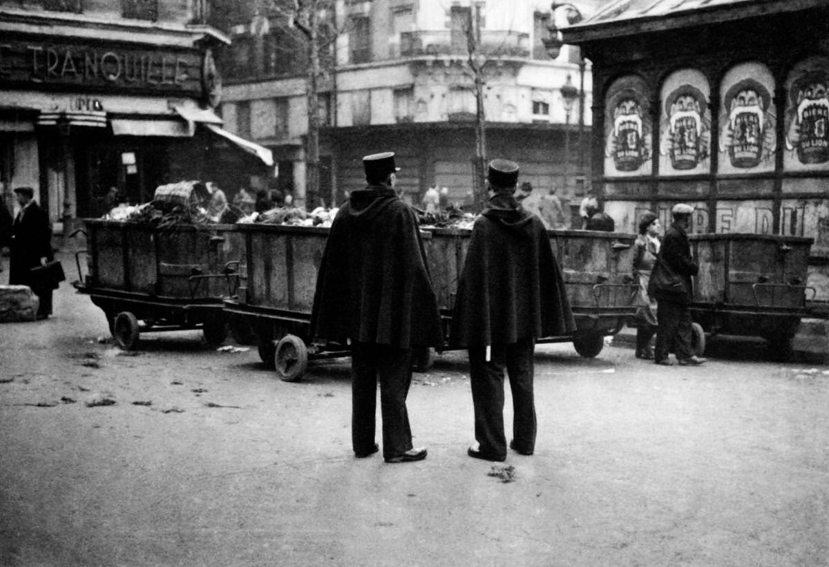 Policemen patrolling Les Halles district ( central food market) at Paris among the workers of the trade, 1931