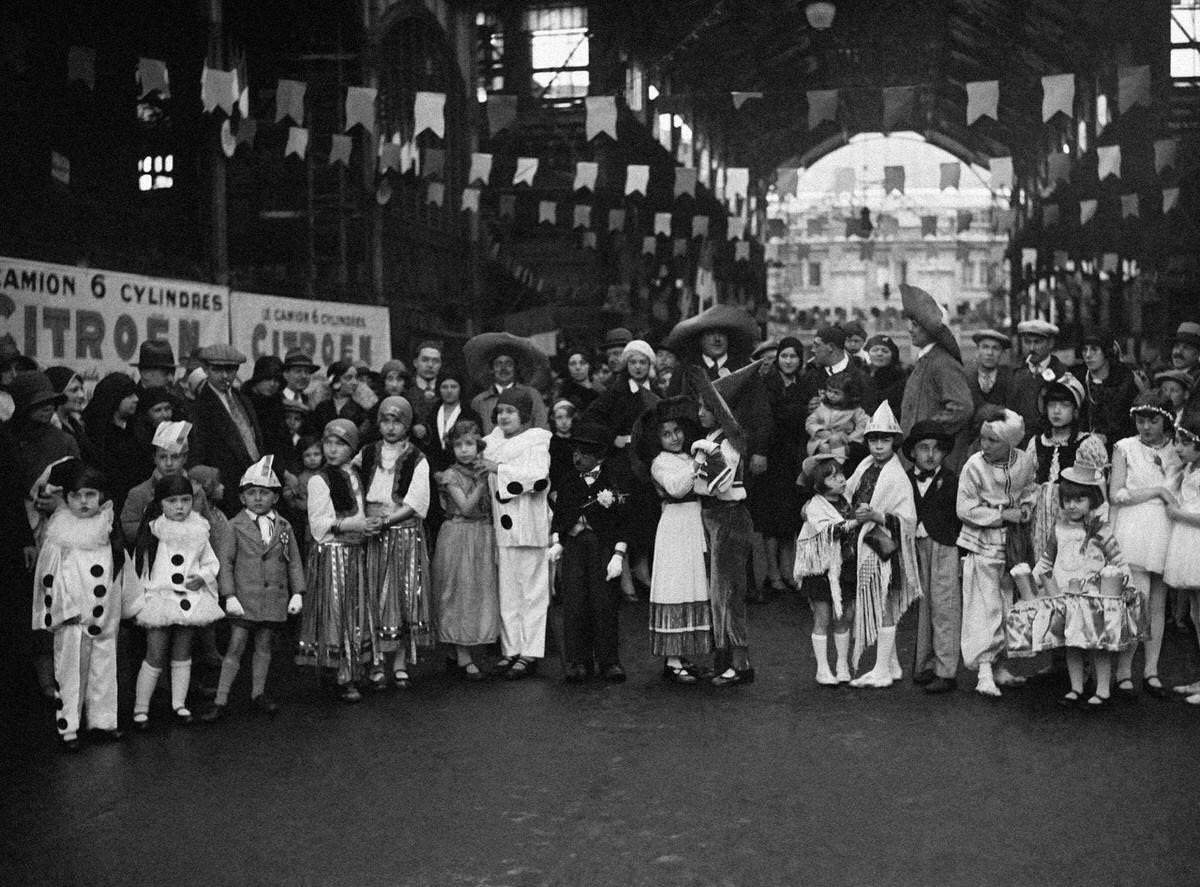 Children in disguise at the Lily of the Valley festival organized by the 'Forts des halles' in the halls of Paris, 1930.