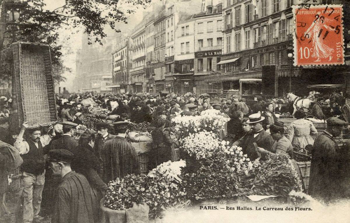 A flower stall and street scene outside Les Halles in Paris, 1908.