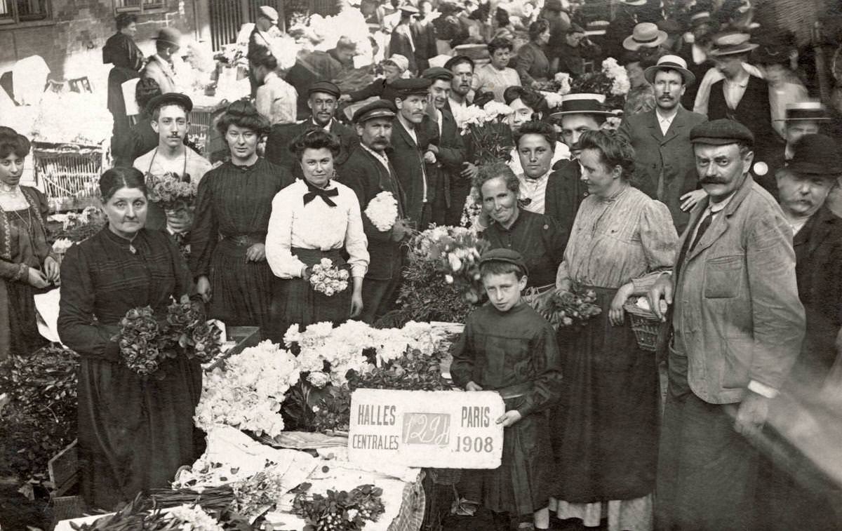 Customers and employees of a market stall selling flowers at Les Halles in Paris, 1908