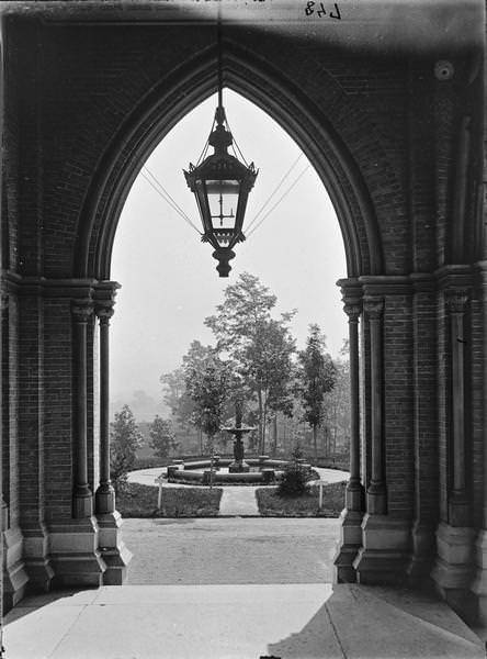 National Home for Disabled Volunteer Soldiers, 1887. View out of entrance to the National Soldiers Home. Fountain and trees framed by arch with hanging lamp.
