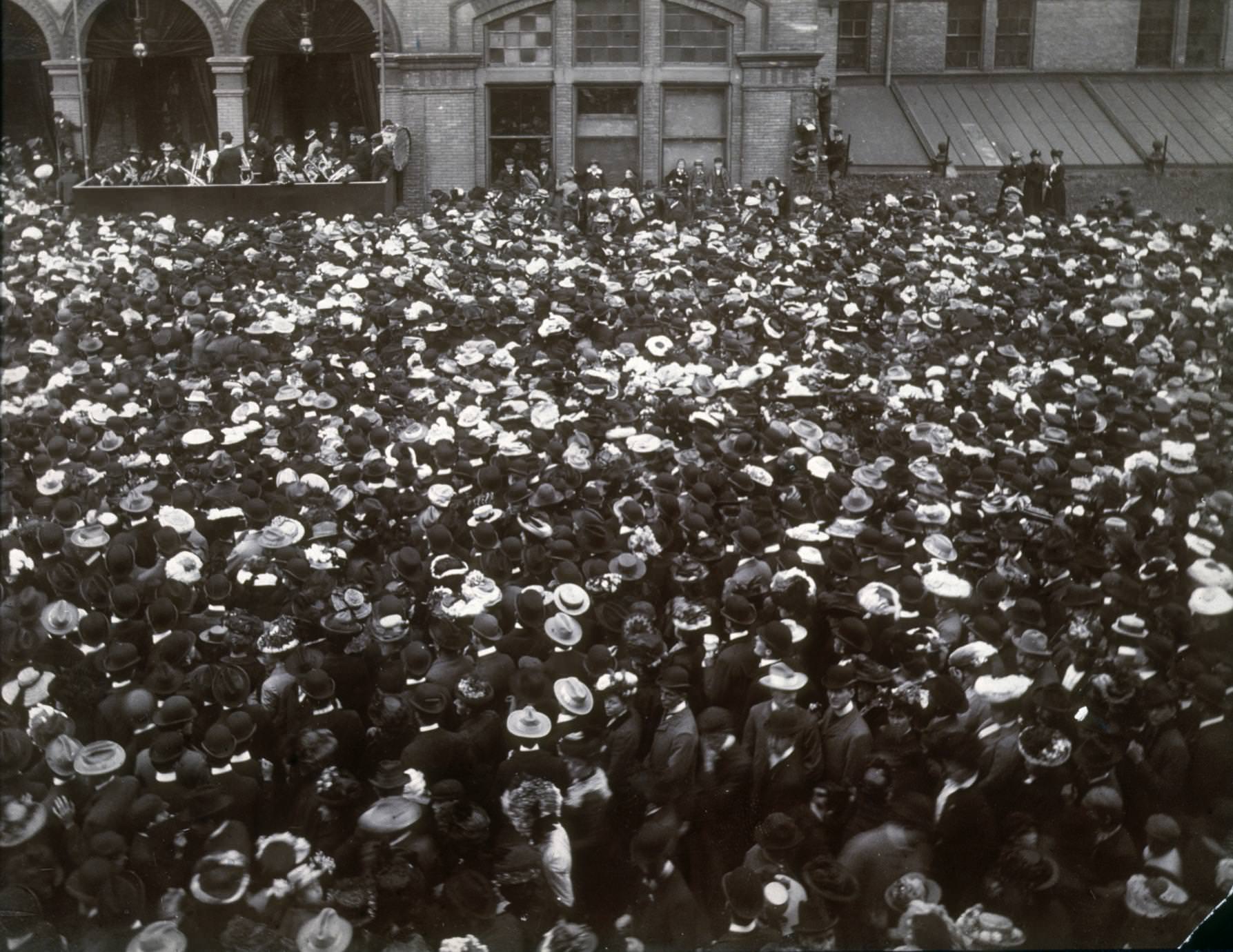 Crowds fill a Milwaukee street as a band plays at a Sängerfest competition, 1886