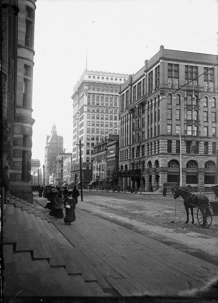East Wisconsin Avenue showing men and women on the sidewalks and the Hotel Pfister in the background, 1893