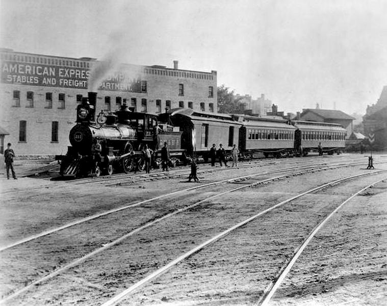 View across railroad tracks of the Chicago, Milwaukee & St. Paul Railway engine #212, also known as the Waukesha Scoot, at Milwaukee's Union Depot, 1894
