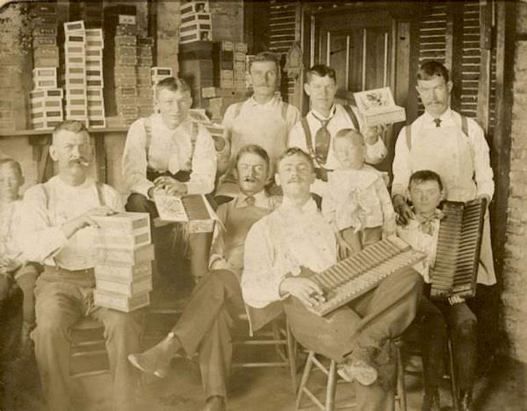 Workers at the Willms cigar factory, Milwaukee, Wisconsin, posing with cigars and cigar boxes, 1896
