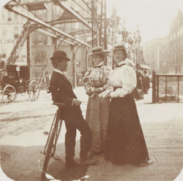 A young man with two young women chatting on Wisconsin Street, 1896