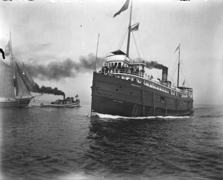 A large steamship, City of Racine, loaded with passengers sails towards Milwaukee Harbor, 1898