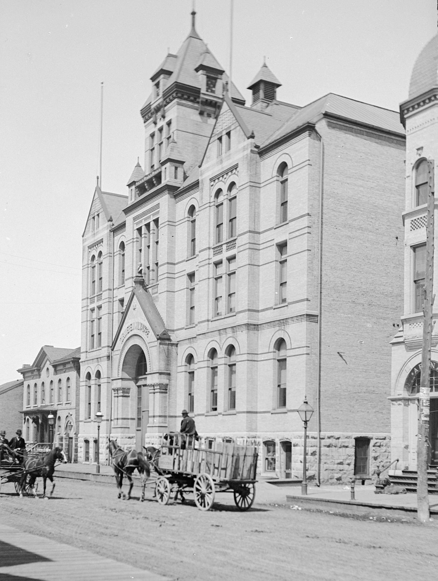 Turner Hall in Milwaukee with horse-drawn wagon passing, Milwaukee, Wisconsin, 1899.