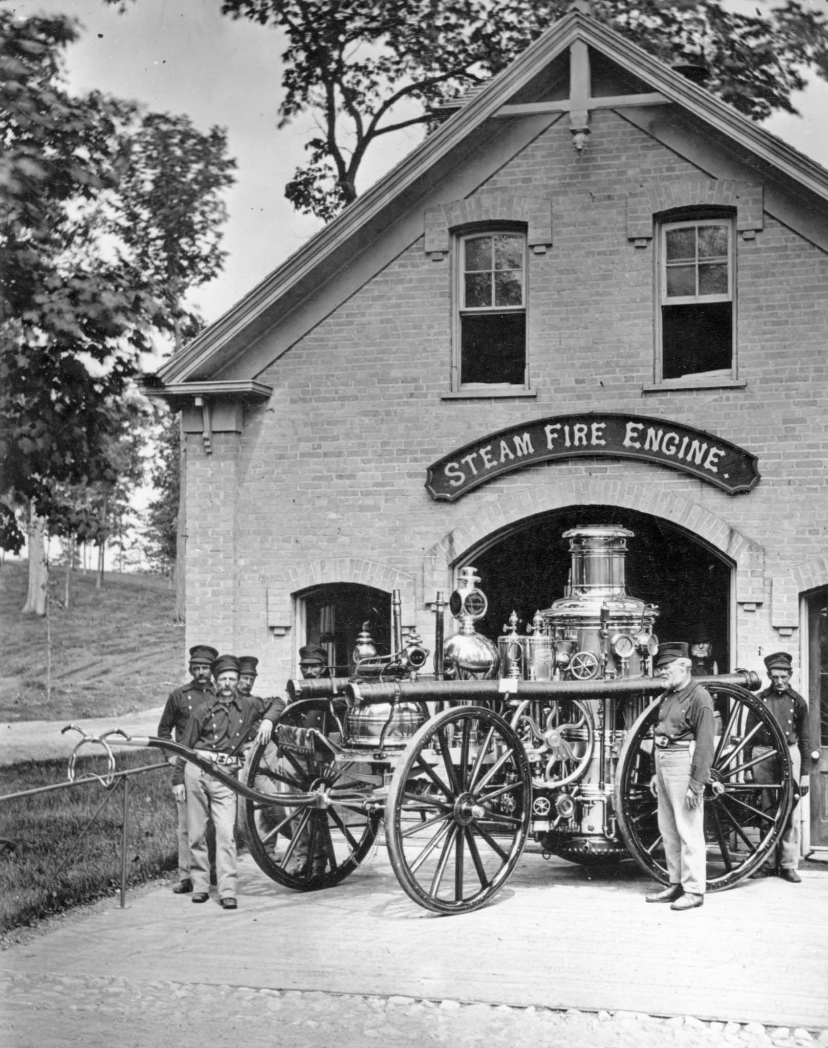 Firefighters stand with steam fire engine in front of fire station at National Soldiers Home, Milwaukee, Wisconsin, May 19, 1887.