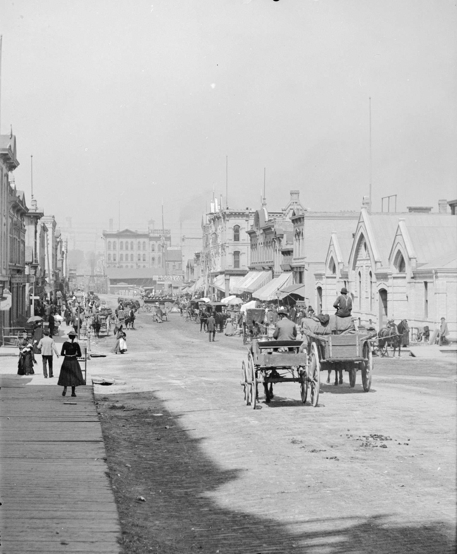 German Market on the right side of the street in the distance, Milwaukee, Wisconsin, 1885.