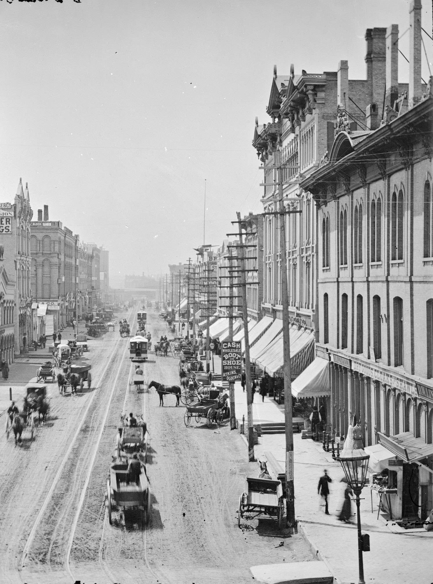 Elevated view of buildings and street traffic, Milwaukee, Wisconsin, 1885.