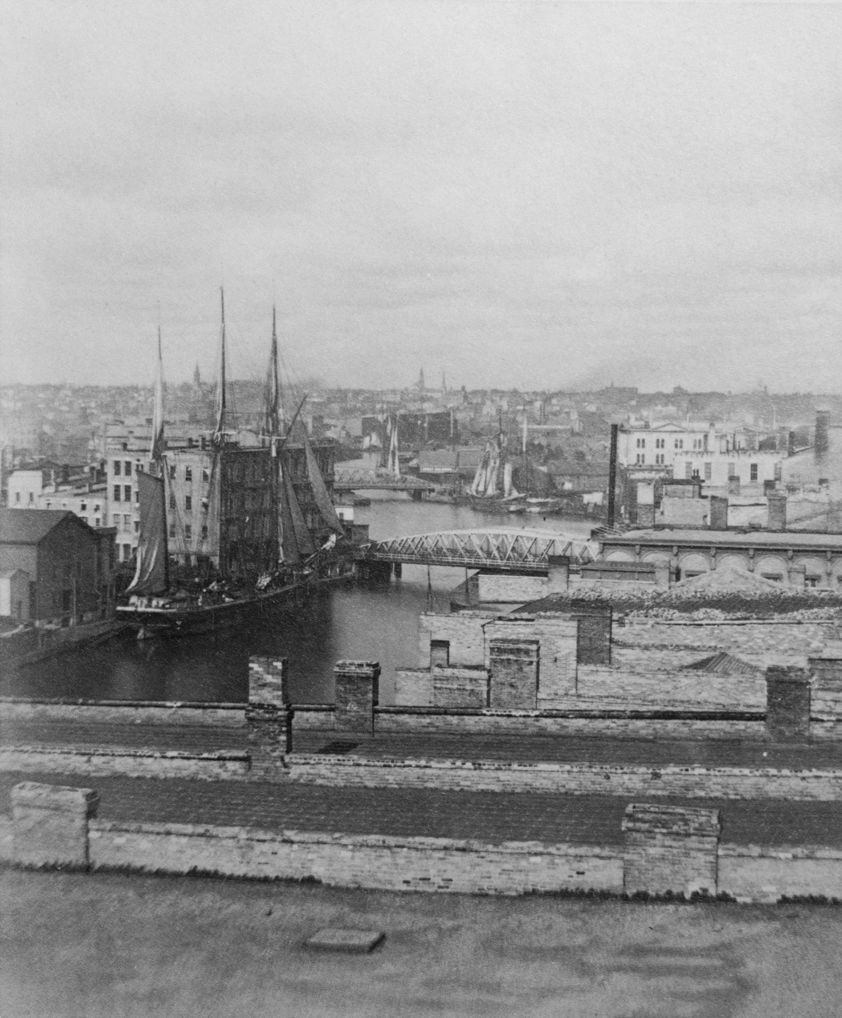 High angle view of a ship moored at a wharf on the Milwaukee River in Milwaukee, Wisconsin, 1875.