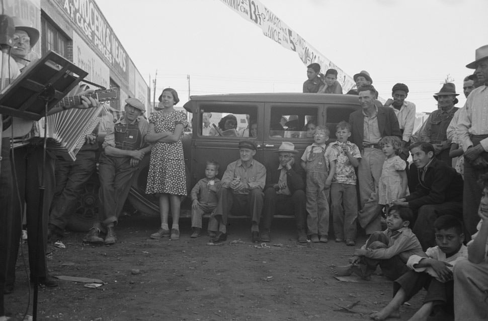 Audience listening to orchestra playing outside grocery store on Saturday afternoon, Phoenix, Arizona, 1940