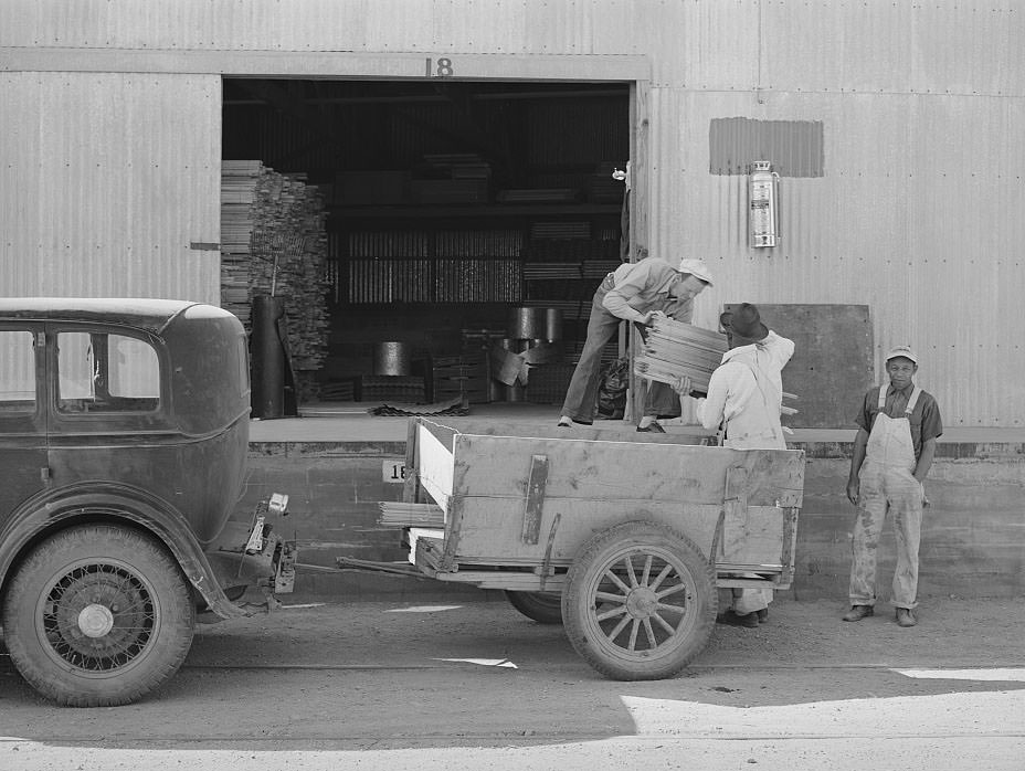 Farmer loading cut lumber from warehouse of the United Producers and Consumers Cooperative, Phoenix, Arizona, 1940