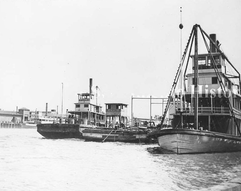 Sacramento River waterfront with the river boats "San Joaquin" and "Flora" and the barge, "Rio Vista", 1880s