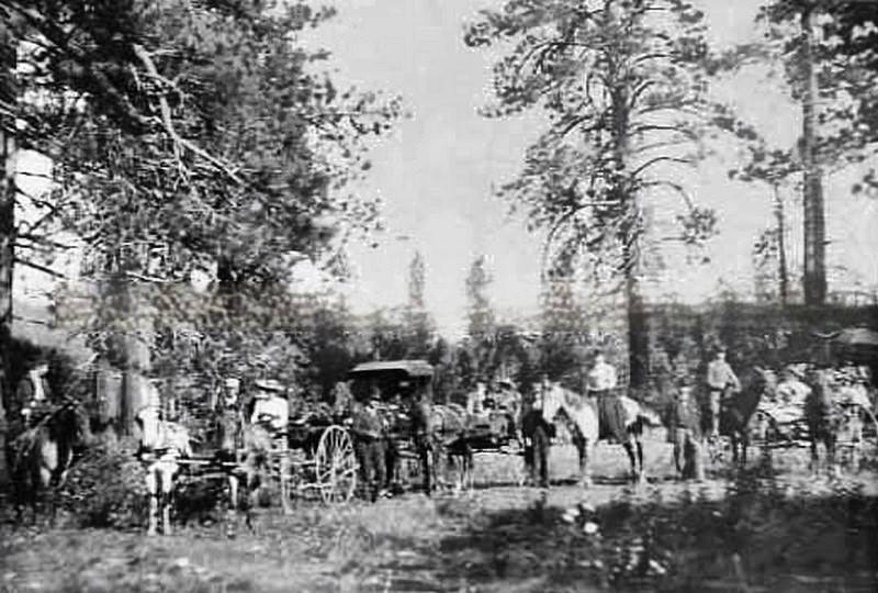 Exterior view of Samuel Luke Howe, Sr. camping in Nevada Scene shows people on horseback and horse drawn carriages, 1880