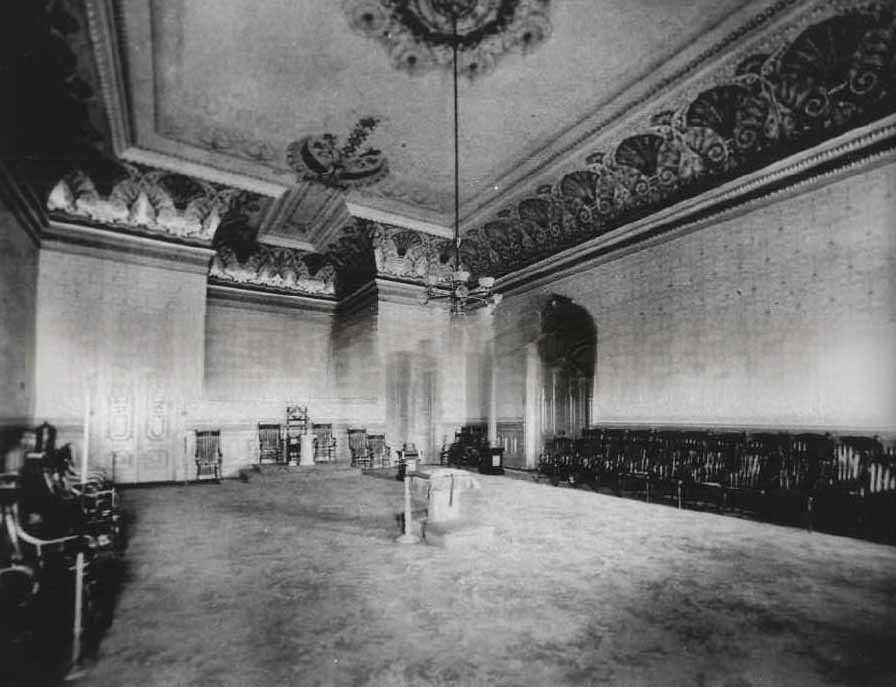 The interior of what appears to be a lodge meeting room, in an unidentified location and decorated in high Victorian style, 1881