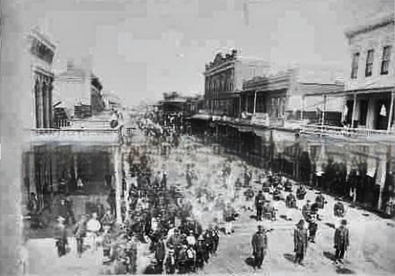 A band marching down an unidentified street in Sacramento, 1885