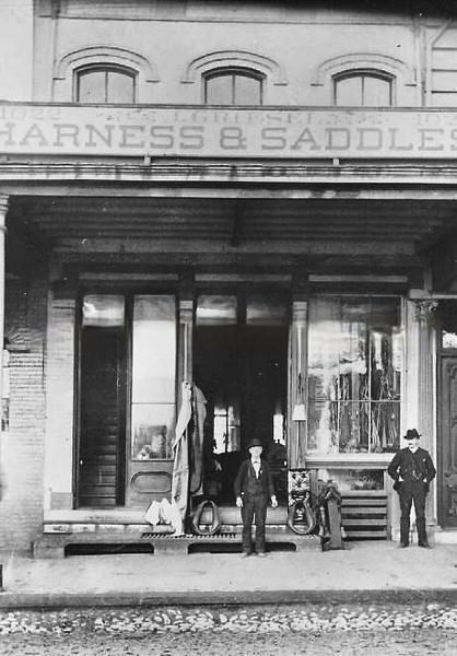 Jacob Griesel poses in front of his harness shop at 1022 J Street, 1887