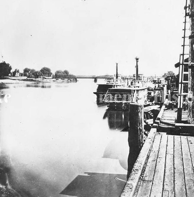 Sacramento River waterfront with the river boats "Dora" and "Flora, 1880s